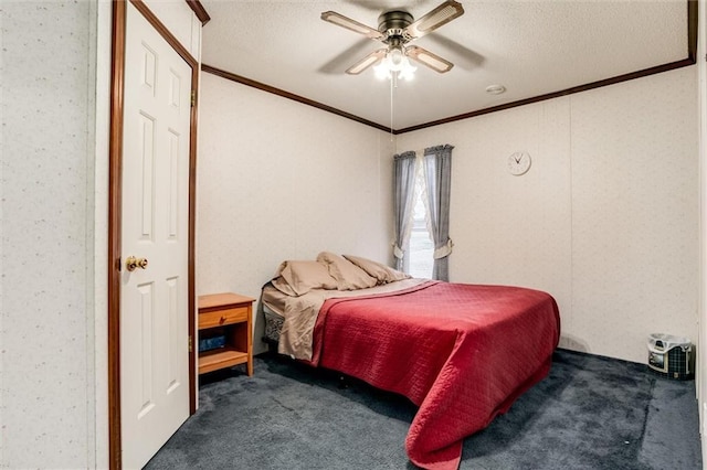 carpeted bedroom with ornamental molding, ceiling fan, and a textured ceiling