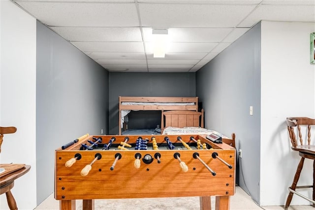 recreation room with carpet flooring and a drop ceiling