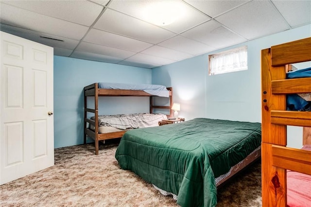 bedroom featuring a paneled ceiling, visible vents, and carpet floors