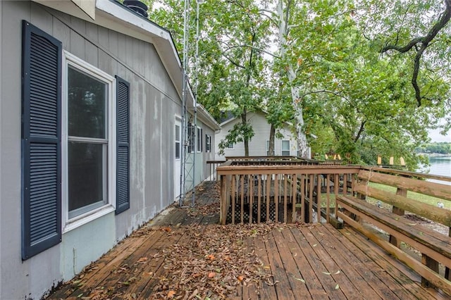 wooden terrace featuring a water view