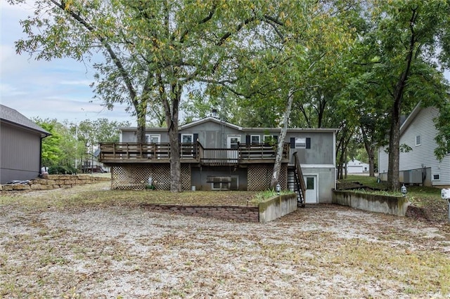 back of house with a wooden deck and stairs