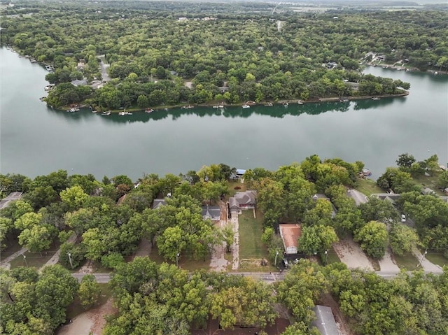 aerial view with a water view and a wooded view