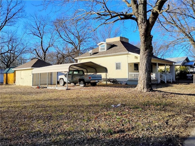 view of side of home featuring a carport and a porch