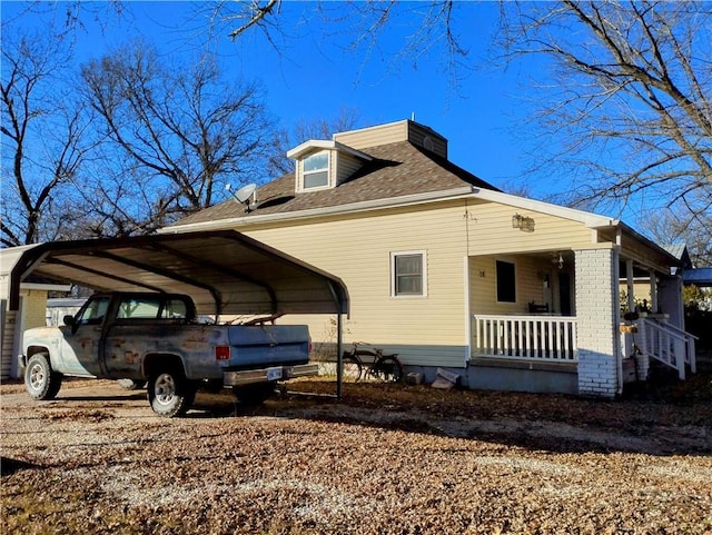 view of side of property featuring a porch and a carport