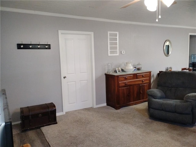 living area featuring ceiling fan, carpet floors, and ornamental molding