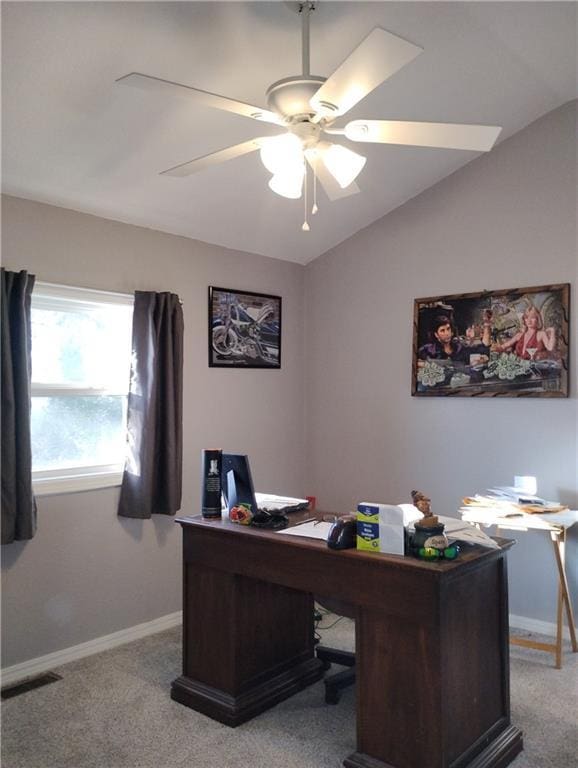 carpeted office space with vaulted ceiling and ceiling fan