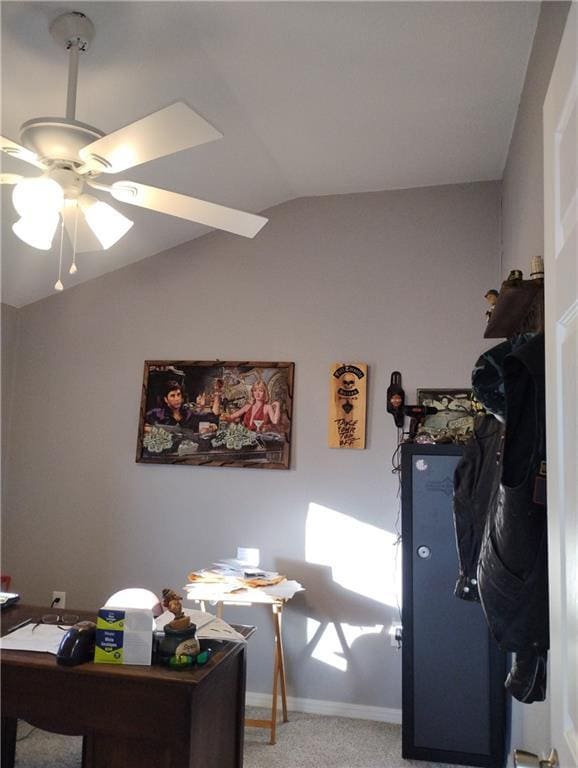 home office featuring carpet, ceiling fan, and vaulted ceiling