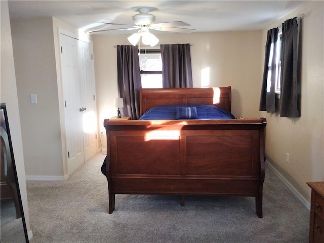 bedroom with ceiling fan, a closet, and carpet floors