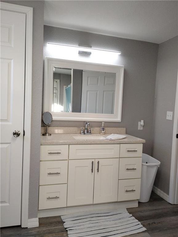 bathroom featuring vanity and hardwood / wood-style floors