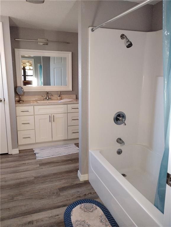 bathroom featuring wood-type flooring, vanity, and shower / tub combo with curtain