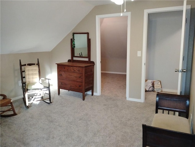 sitting room with light carpet and vaulted ceiling