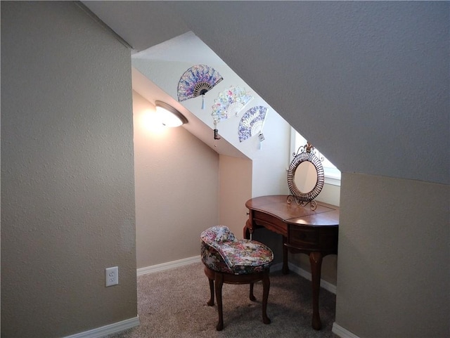 carpeted office with lofted ceiling