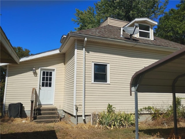 view of home's exterior with a carport