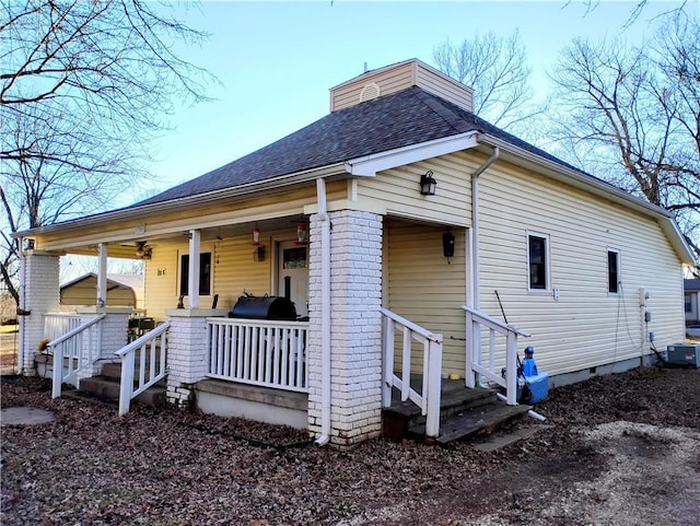 exterior space with a porch and central AC