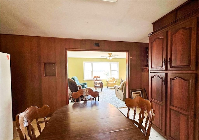 10784 SW 70th St, Chetopa, KS 67336 - dining area with wooden walls and a ceiling fan