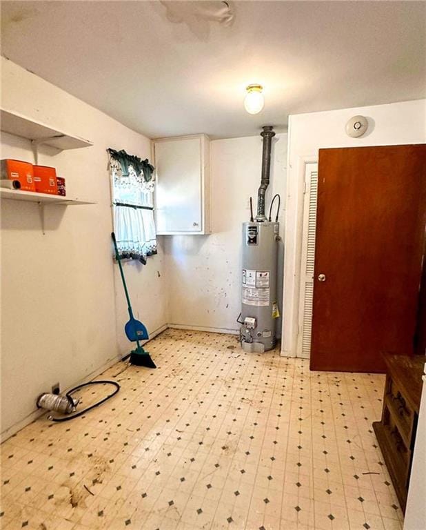 10784 SW 70th St, Chetopa, KS 67336 - laundry area with water heater and light floors