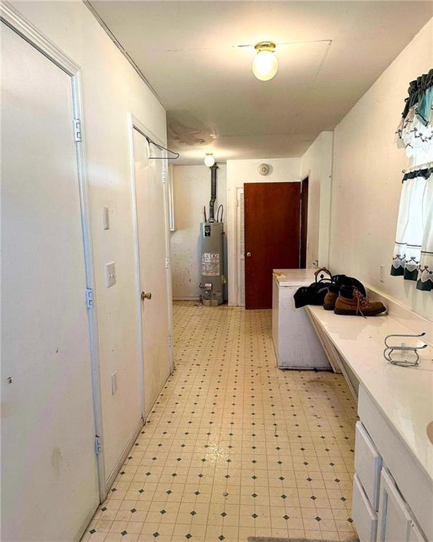 10784 SW 70th St, Chetopa, KS 67336 - hallway with water heater and light floors