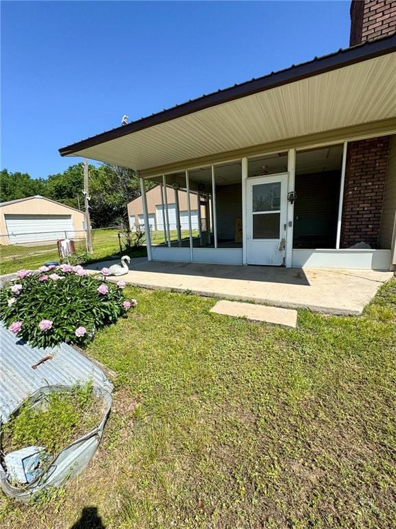 10784 SW 70th St, Chetopa, KS 67336 - exterior space with a lawn, brick siding, a chimney, and a garage