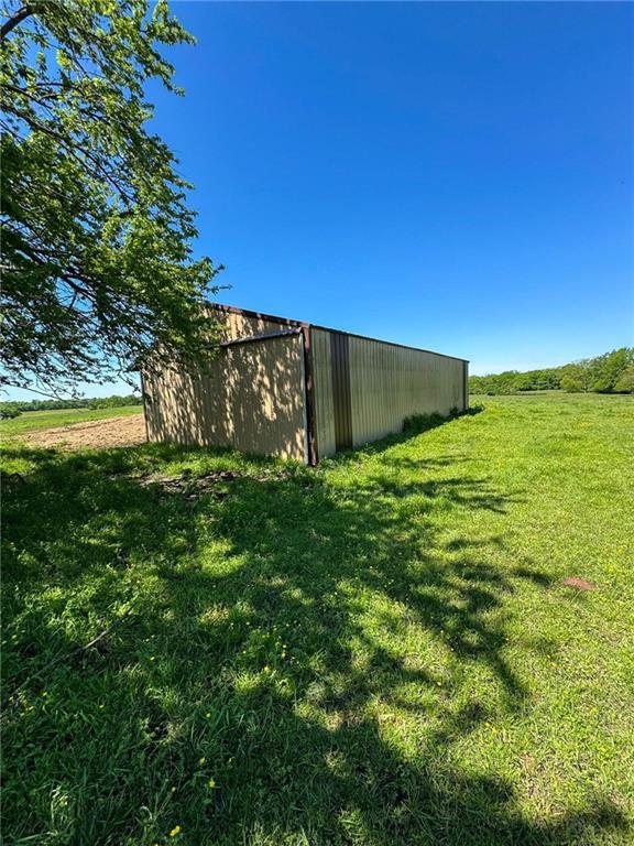 10784 SW 70th St, Chetopa, KS 67336 - view of grassy yard featuring an outbuilding