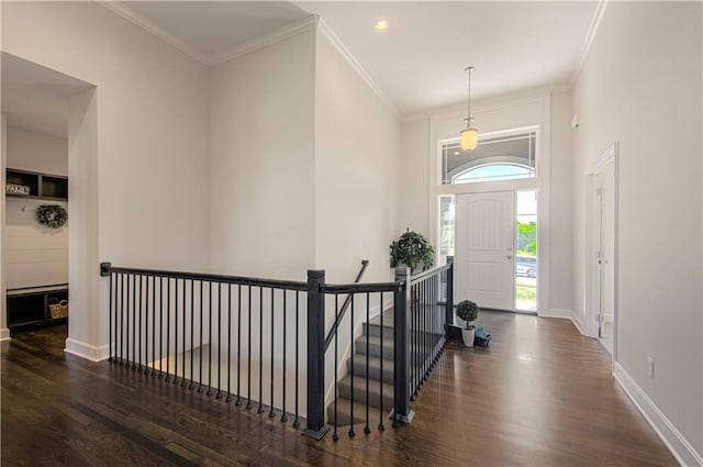 entryway featuring ornamental molding, recessed lighting, wood finished floors, and baseboards