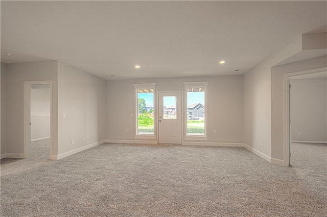 empty room with carpet floors, baseboards, and recessed lighting