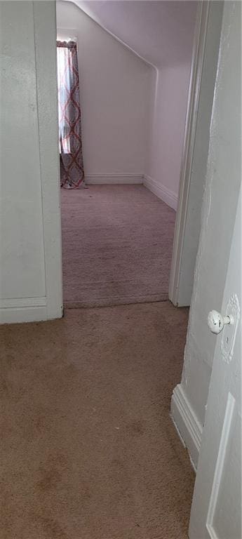 hall featuring light colored carpet