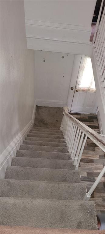 staircase featuring hardwood / wood-style floors