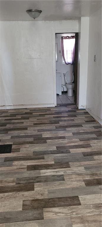 empty room featuring dark wood-type flooring