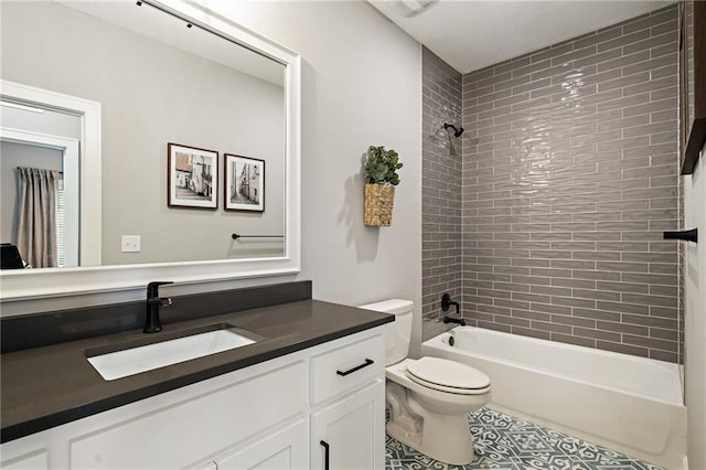 full bathroom featuring tile patterned floors, tiled shower / bath combo, toilet, and vanity