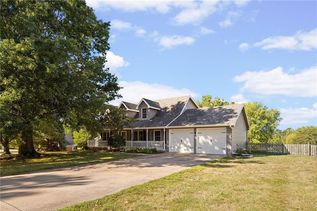 cape cod house featuring covered porch, a front yard, and a garage