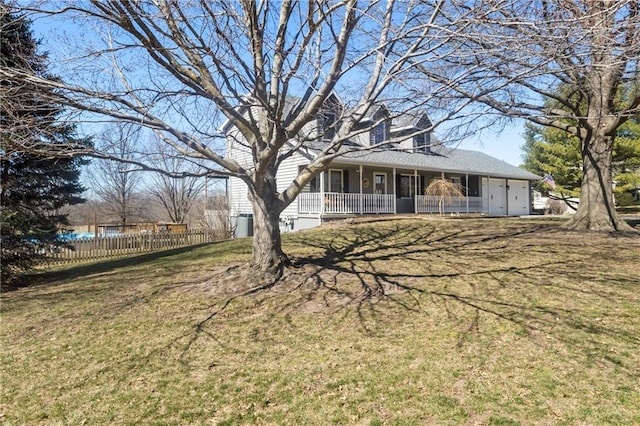 view of yard featuring fence and covered porch