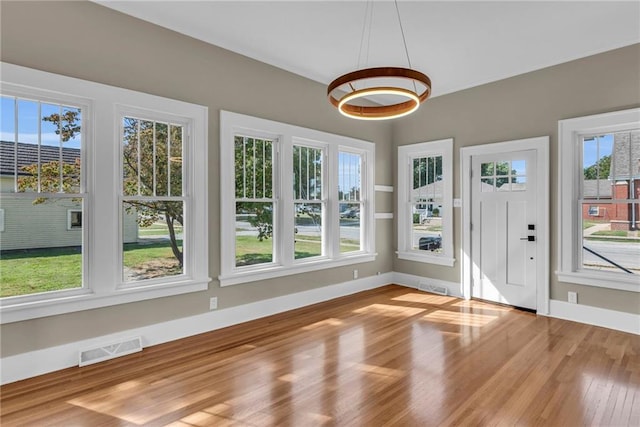 unfurnished sunroom featuring a wealth of natural light