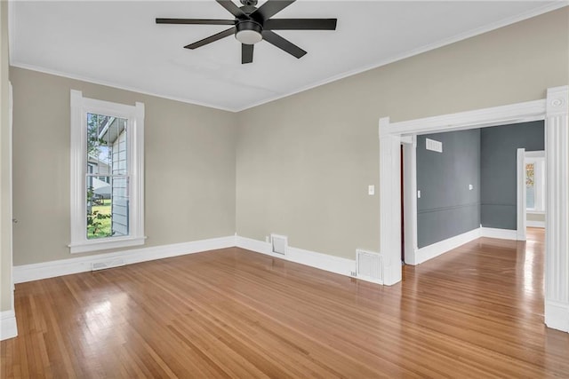 empty room with ornamental molding, ceiling fan, and hardwood / wood-style floors