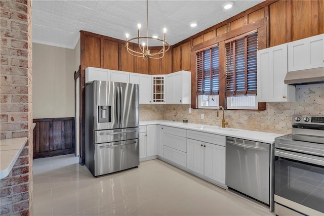 kitchen featuring appliances with stainless steel finishes, an inviting chandelier, sink, and white cabinets