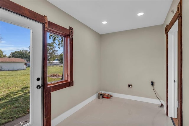 interior space featuring light tile patterned flooring, plenty of natural light, and electric dryer hookup