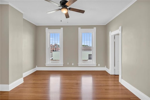 unfurnished room with ceiling fan, hardwood / wood-style flooring, and a healthy amount of sunlight