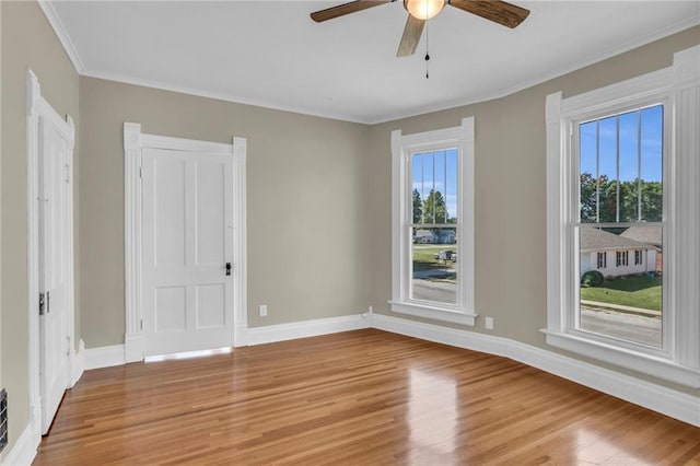 unfurnished room featuring hardwood / wood-style floors, ceiling fan, and a wealth of natural light