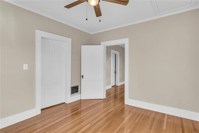 spare room featuring wood-type flooring, crown molding, and ceiling fan