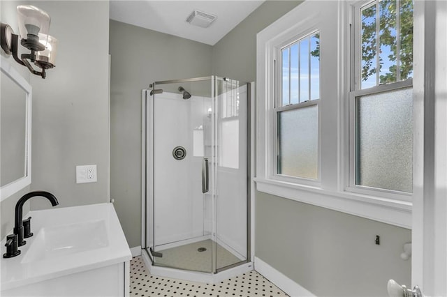 bathroom featuring vanity and a shower with shower door