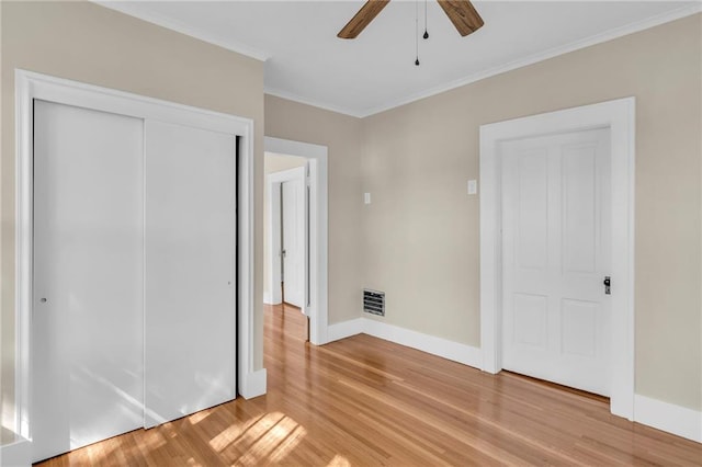 unfurnished bedroom with ornamental molding, ceiling fan, and light hardwood / wood-style flooring