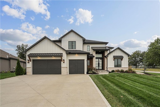 modern inspired farmhouse featuring a garage and a front yard