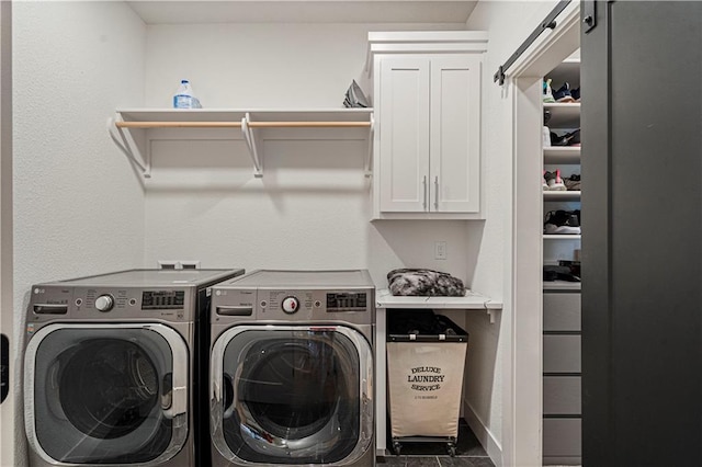 laundry area featuring separate washer and dryer and cabinets