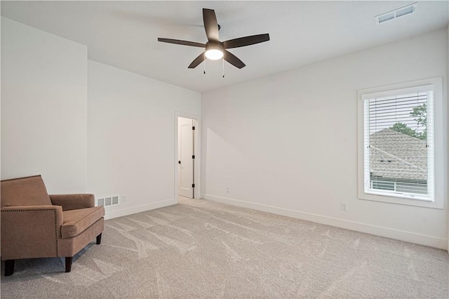 living area featuring ceiling fan and light colored carpet