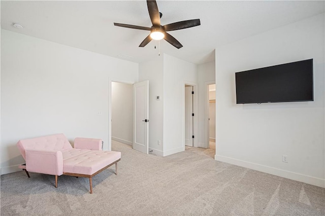 living area with ceiling fan and light colored carpet