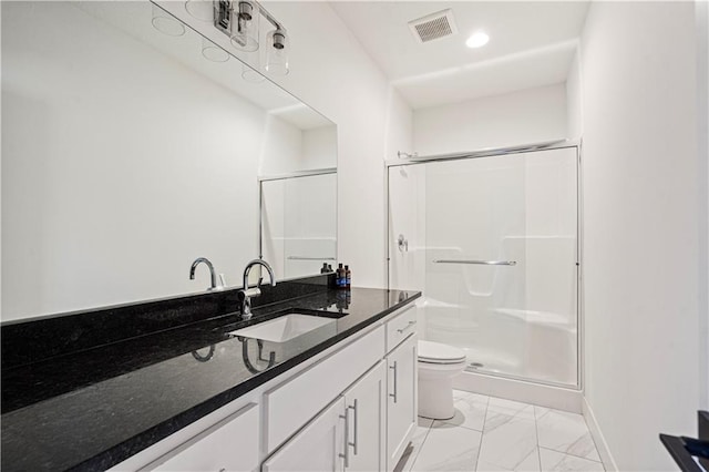 bathroom with walk in shower, vanity, and toilet