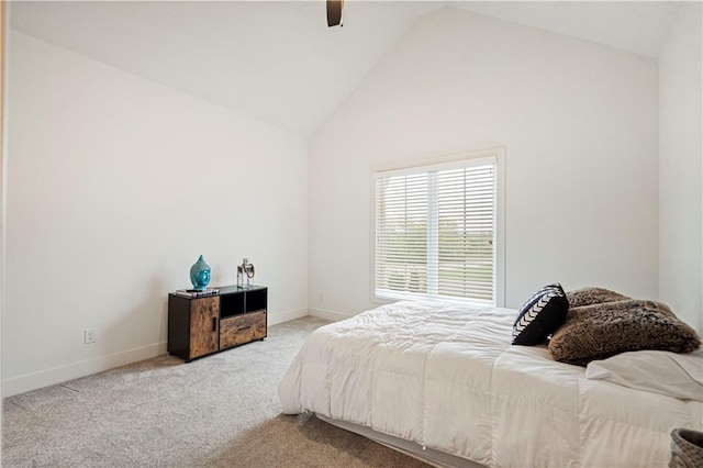 bedroom with ceiling fan, light colored carpet, and high vaulted ceiling