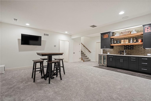 bar with light carpet and sink