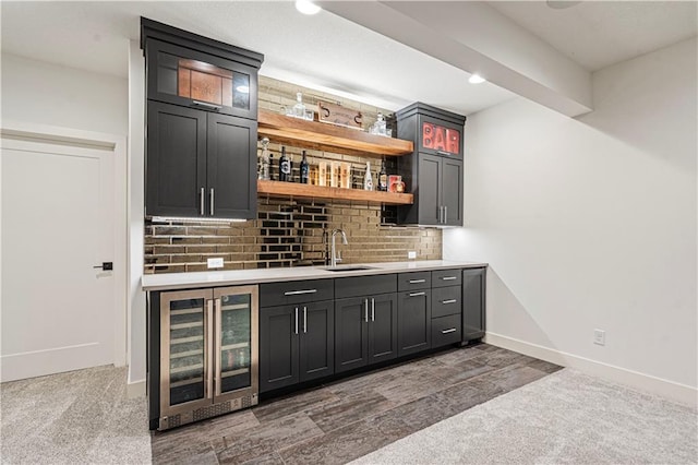 bar featuring backsplash, dark colored carpet, sink, and wine cooler