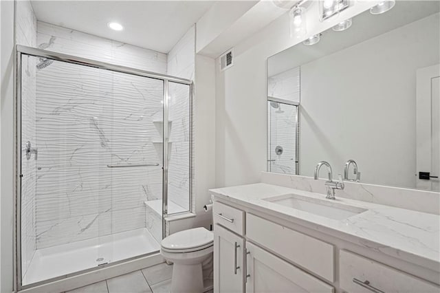 bathroom with tile patterned floors, an enclosed shower, vanity, and toilet