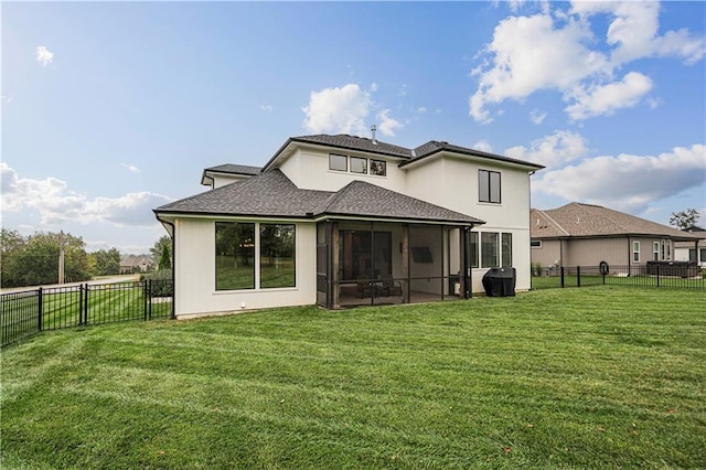 rear view of property featuring a sunroom and a lawn